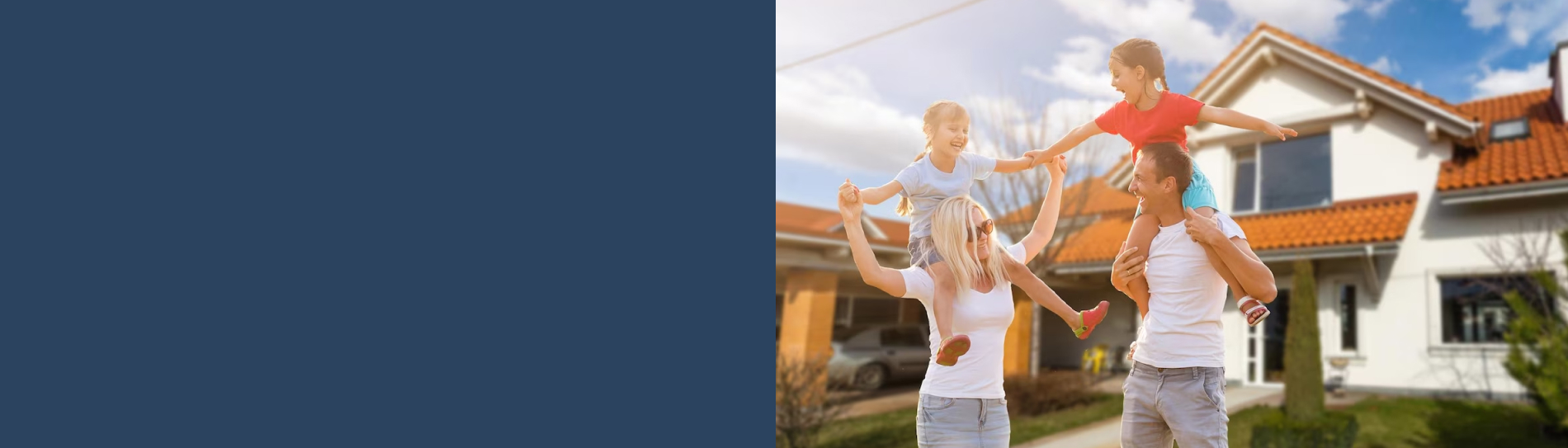 A family playing in front of their home
